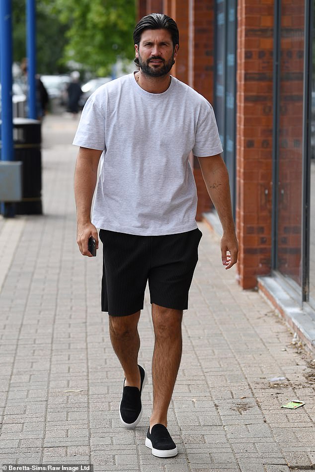 Meanwhile, Dan opted for a plain casual grey t-shirt with a pair of black shorts and slip-on sneakers.