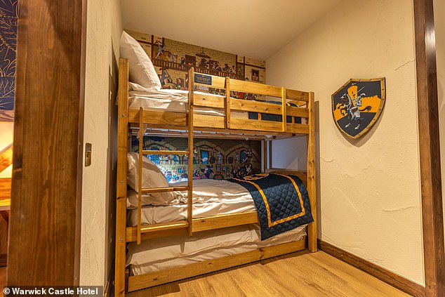 Children's bunk beds, along with a trundle bed, are installed in an anteroom next to the master bedroom, as shown in the image.