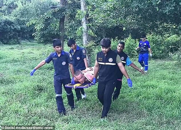 He is carried away on a stretcher after being arrested by police in Thailand