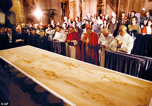 Many believe the Shroud of Turin (pictured) is the cloth in which Jesus' body was wrapped after his death, but not all experts are convinced it is authentic.