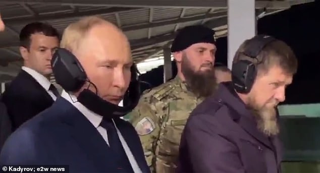 He visited a shooting range with Chechen warlord Ramzan Kadyrov (pictured, right)