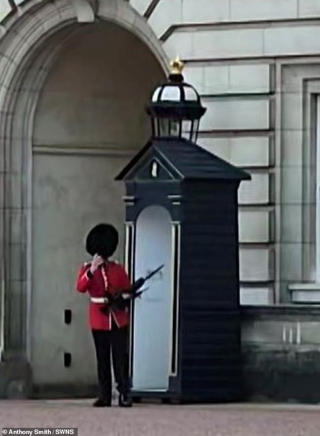 The royal guard quickly adjusted his hat before continuing as normal.