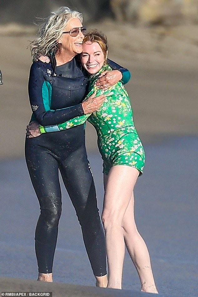 As cameras rolled, Lohan sported a green wetsuit with a white floral print that showed off her endless legs.