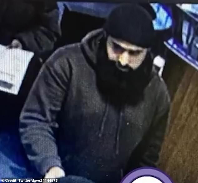 The suspect, pictured, was filmed punching the woman in the face before leaving the restaurant in Stratford, London. Police are now searching for him.