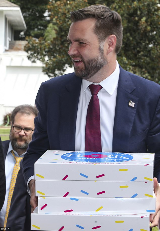 He was seen carrying boxes of cakes as he left the candy store on his way to a demonstration.