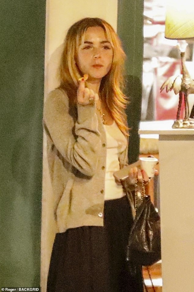 Kiernan looked chic in a long black skirt and beige sweater over a low-cut white tank top.