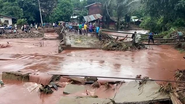 Water covers the street after heavy rains overnight triggered a landslide and flooding