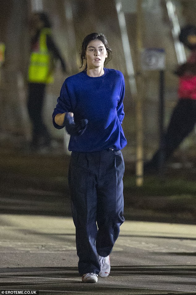 Gracie cut a modern figure in tailored blue trousers and a matching knitted jumper.