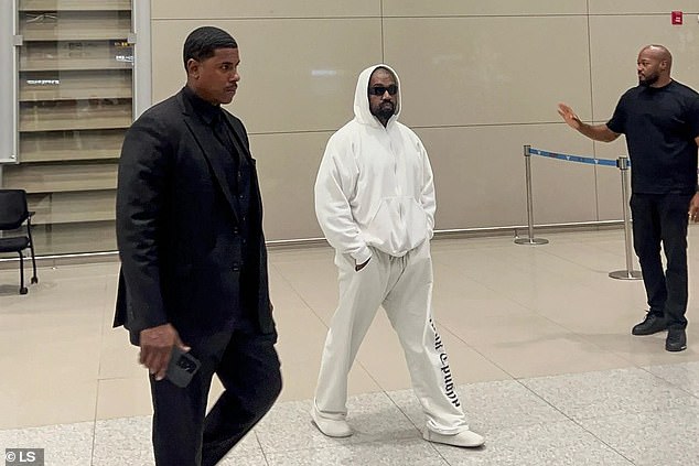 Kanye also kept it casual in a simple white hoodie and matching sweatpants, shielding his eyes with black sunglasses.