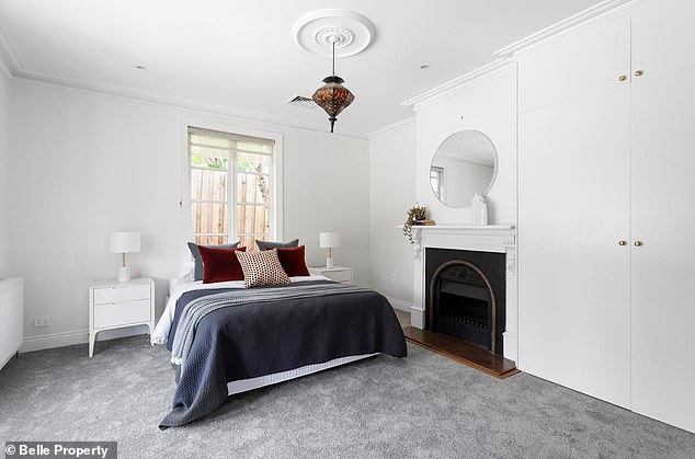 Built in the 1850s, the property is a magnificent combination of Old World charm and sleek modern design. Pictured: one of the five bedrooms