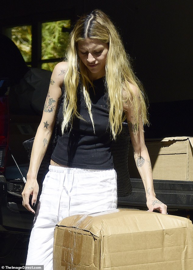 The 1975 singer and his new fiancée Gabbriette Bechtel, 26, carried boxes up to their luxurious new apartment.