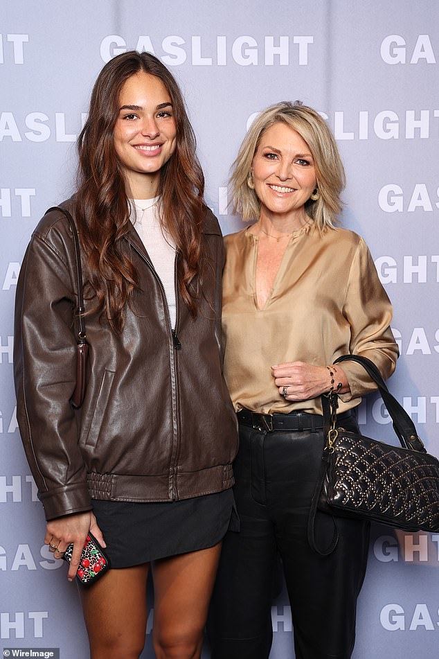 She posed alongside model Jade Julian (left), who dazzled in a brown leather coat, white top and black miniskirt.