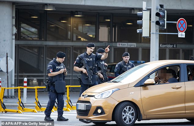 Armed Austrian police officers patrol outside the Ernst Happel Stadium in Vienna, Austria, August 21, 2024.