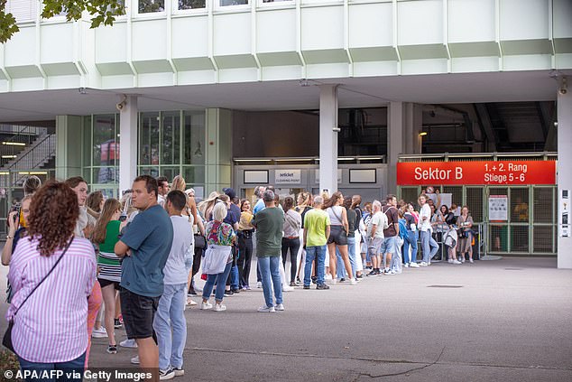 Fans queue outside the Ernst Happel Stadium in Vienna, Austria, on August 21, 2024, ahead of the first in a series of concerts by British rock band Coldplay.