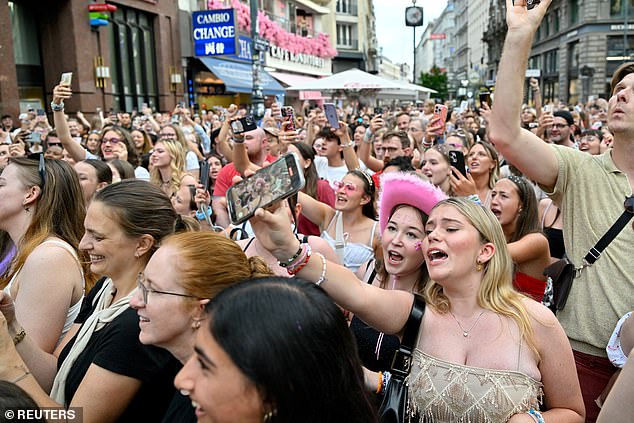 Taylor Swift fans react as they sing together in front of St. Stephen's Cathedral following the cancellation of three Taylor Swift concerts at the Ernst Happel Stadium due to a planned attack at the venue, in Vienna, Austria, August 9, 2024