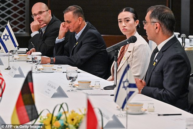 Noa listens as Israel's ambassador to Japan Gilad Cohen (right) speaks during a meeting with G7 embassy representatives during a visit to Tokyo on August 21.