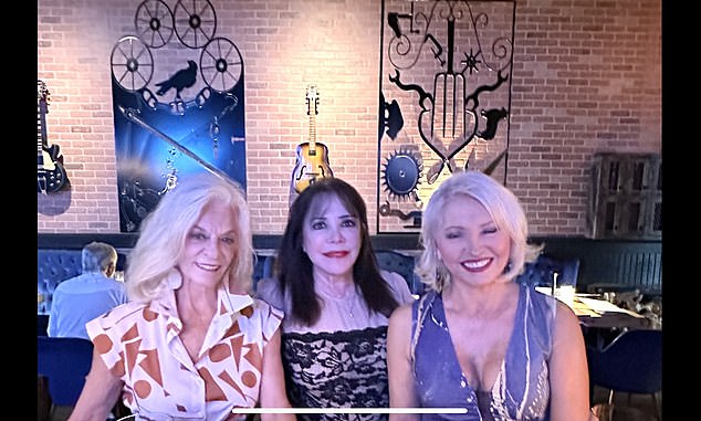 Shje is pictured below with two friends on a night out before her surgery debacle.