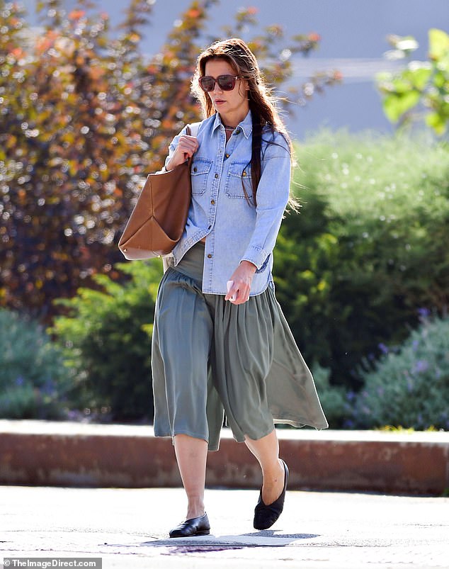 The flat black ballet flats looked comfortable as she carried a light brown leather bag from Khaite on her shoulder as well as a backpack. With minimal makeup and large sunglasses covering her face, the star appeared to be going unnoticed.