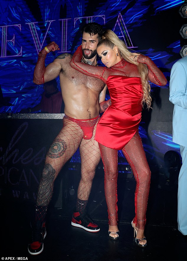 Carmen was seen dancing with a scantily clad dancer in a red thong and fishnet stockings.