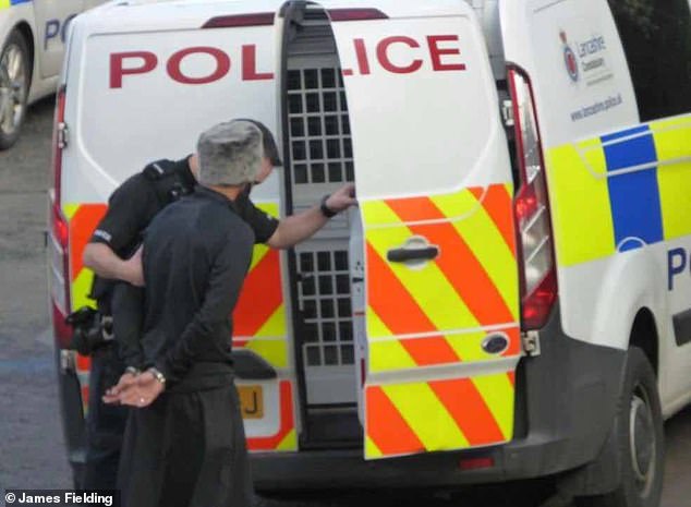 Akram was arrested in Blackburn in 2018 (pictured) after refusing to pay rent to his landlord. Police vans are seen at the scene