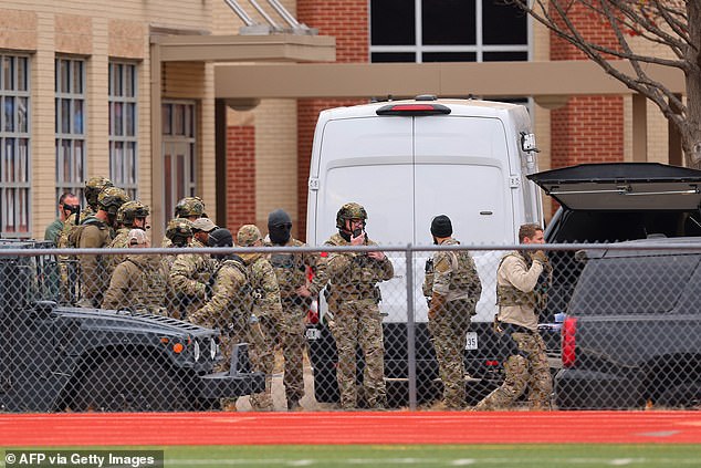 SWAT team members deploy near the Congregation Beth Israel synagogue in Colleyville, Texas