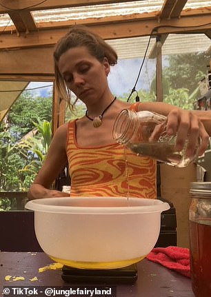 Zoe is pictured above making bread in her kitchen.