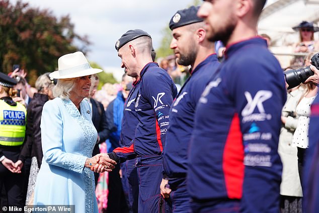 Pictured: The royals shake hands with members of the parachute display team during day four of the Sky Bet Ebor Festival at York Racecourse.