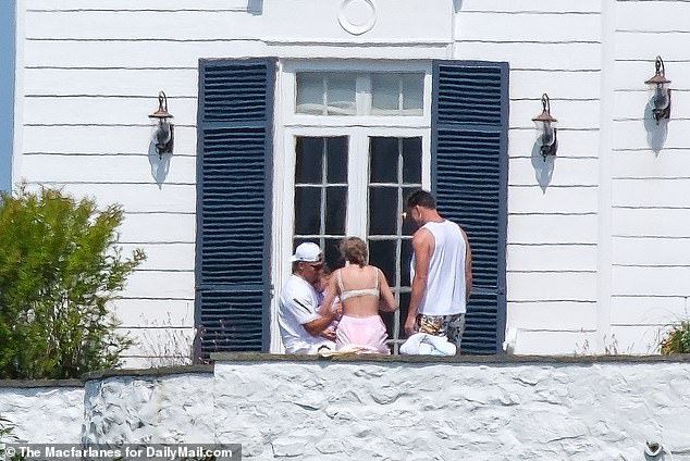 Blake was likely excited to spend quality time with the 34-year-old pop star (M), who was spotted on a balcony with her boyfriend Travis Kelce (L) and Kansas City Chiefs teammate Patrick Mahomes (R) and their three-year-old daughter Sterling Mahomes.