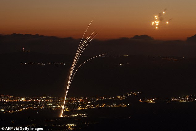 Rockets fired from southern Lebanon are intercepted by Israel's Iron Dome air defense system over the Upper Galilee region in northern Israel on August 23, 2024.