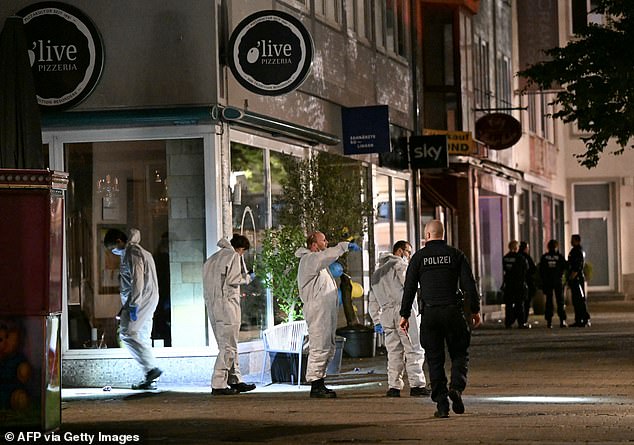 Forensic police inspect the area where at least three people were killed and several others injured when a man attacked them with a knife on the evening of August 23, 2024 in Solingen in the early morning of August 24, 2024.