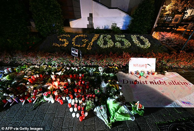 Candles and flowers and the inscription. "Why? You are not alone" They are shown on the evening of August 24, 2024, near the area where three people were killed and several others injured.