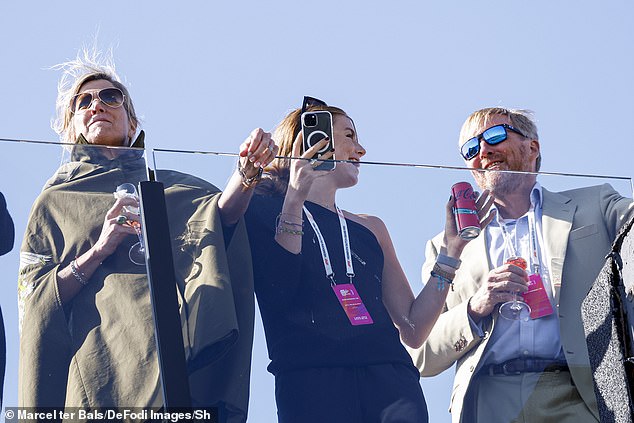 Alexia seemed engrossed in the race, filming the drivers racing around the track with her smartphone while chatting with her father.