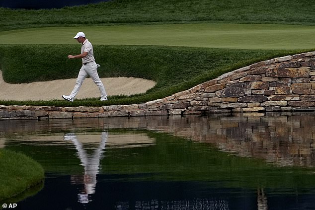 The four-time major champion angrily picked up his club from the water before storming off.