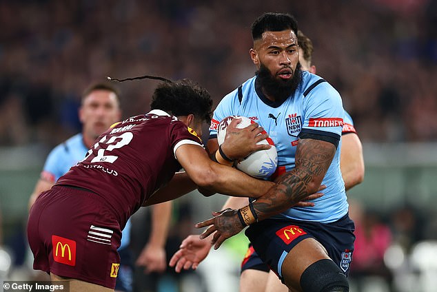 Payne Haas (pictured carrying the ball for New South Wales in the second game of this year's State of Origin series) has pushed ahead with his football despite the serious charges facing his mother.