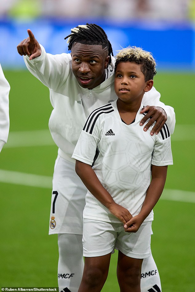 Kim watched from the stands as Saint looked excited as he walked out onto the pitch with the players ahead of their 3-1 win over Valladolid; pictured with Vinicius Jr.