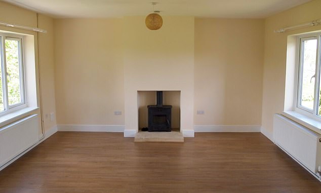 The modest living room has a cozy wood stove for the winter months.