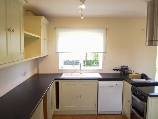 The semi-detached property features an open-plan kitchen/living room complete with a wood burning stove.