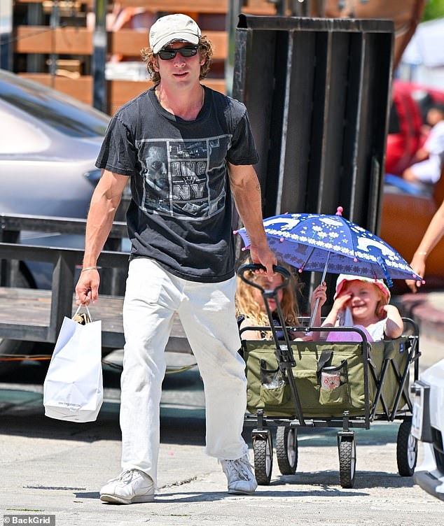 The 33-year-old actor wore a King Of New York T-shirt featuring an image of Christopher Walken along with grey trousers and matching white sneakers.