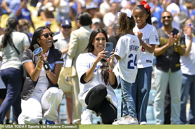 Vanessa and her and Bryant's daughters, Natalia (left), Capri (second from right) and Bianka, gathered on the field before the game.