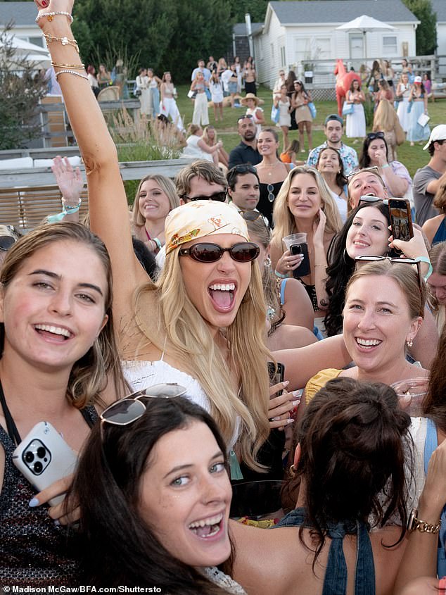 She was spotted with a drink in her red manicured hand during Saturday's outdoor party.