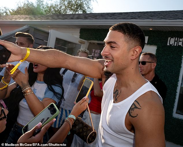 Miguel was dressed casually in a white tank top.