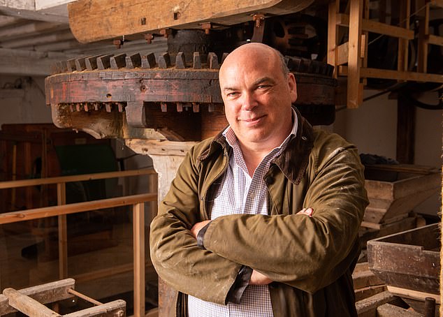 Tech entrepreneur Lynch with his renovated windmill on his Suffolk farm