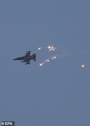 An Israeli fighter jet fires flares over an area near the Lebanese-Israeli border.