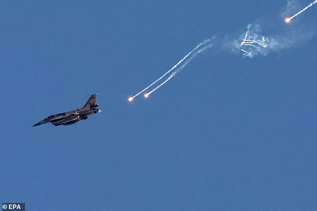 An Israeli fighter jet fires flares over an area near the Lebanese-Israeli border, as seen from northern Israel, August 25, 2024.