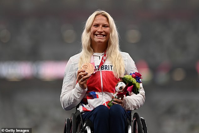 Kinghorn poses on the podium with the bronze medal she won at the Tokyo 2021 Games