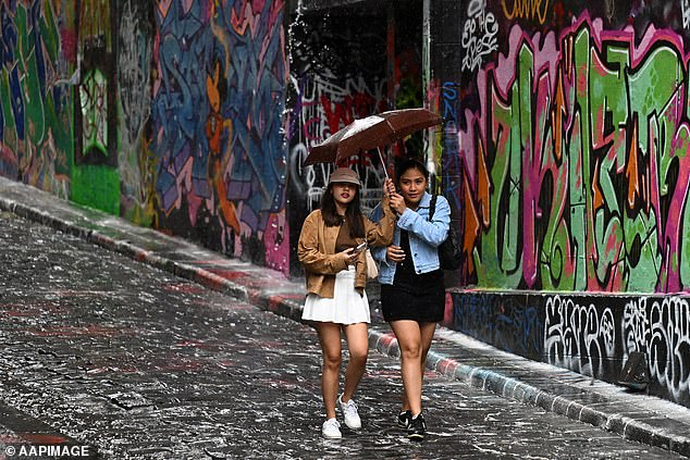 Victoria is likely to experience showers and damaging gusts, especially on Wednesday when winds could reach up to 100km off the coast (pictured: people walking in Melbourne)