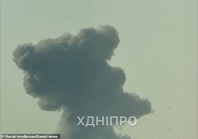 Loud explosions were recorded in kyiv, Kharkiv, Dnipro and Zaporizhia. Pictured: Smoke is seen during an attack in Dnipro