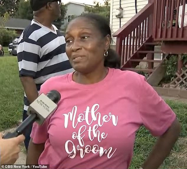 At a vigil for the two men, Walker's mother (pictured) was seen wearing a shirt 