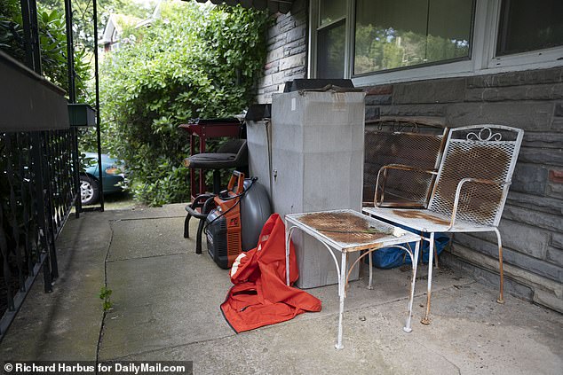 Rusty chairs and other junk sit outside the old house the brothers were planning to sell.