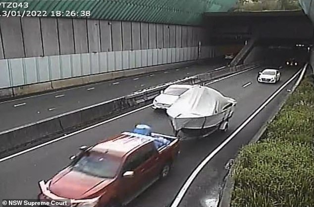 Stein exiting Lane Cove tunnel with barrel on back covered by blue tarp